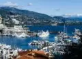 Breathtaking view of Monaco marina with luxurious yachts and scenic backdrop.