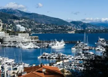 Breathtaking view of Monaco marina with luxurious yachts and scenic backdrop.