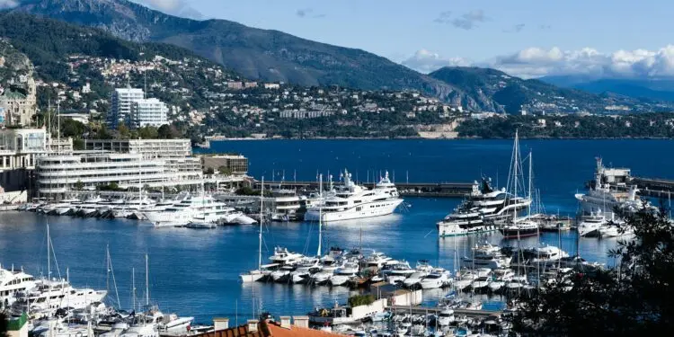Breathtaking view of Monaco marina with luxurious yachts and scenic backdrop.