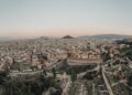 Greece Golden Visa: thresholds double and demand persists — A stunning aerial view of Athens cityscape at sunrise, showcasing historical landmarks.