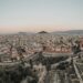 Greece Golden Visa: thresholds double and demand persists — A stunning aerial view of Athens cityscape at sunrise, showcasing historical landmarks.