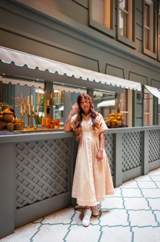 Iesha Vincent in a maxi dress and white sneakers, styled for lifestyle content