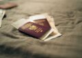 Second Passport: Investment Routes and Costs in 2026 — A close-up of a Polish passport and travel documents placed on a fabric surface, symbolizing travel and identity.