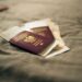 Second Passport: Investment Routes and Costs in 2026 — A close-up of a Polish passport and travel documents placed on a fabric surface, symbolizing travel and identity.