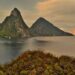 Citizenship by Investment St Lucia: 2026 Complete Programme Guide — A breathtaking sunset view of the Pitons in St. Lucia with lush greenery and calm sea.