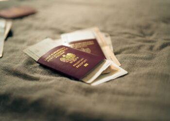 Second Passport: Investment Routes and Costs in 2026 — A close-up of a Polish passport and travel documents placed on a fabric surface, symbolizing travel and identity.