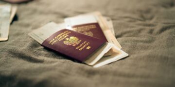 Second Passport: Investment Routes and Costs in 2026 — A close-up of a Polish passport and travel documents placed on a fabric surface, symbolizing travel and identity.