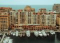 Tax-Free Countries in Europe: Monaco, Gibraltar and Territorial Rules — A stunning aerial photo showcasing luxury yachts moored at a waterfront with apartment buildings in Monaco.
