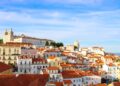 Portugal Citizenship by Investment: What Changed in 2026 and What Works Now — A scenic view over Lisbon's historic Alfama district showcasing traditional architecture under a clear sky.