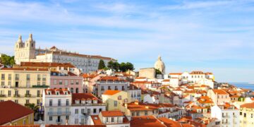 Portugal Citizenship by Investment: What Changed in 2026 and What Works Now — A scenic view over Lisbon's historic Alfama district showcasing traditional architecture under a clear sky.