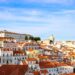 Portugal Citizenship by Investment: What Changed in 2026 and What Works Now — A scenic view over Lisbon's historic Alfama district showcasing traditional architecture under a clear sky.
