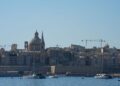 Citizenship by Investment Malta: What Ended and What Remains in 2026 — Beautiful view of Valletta with boats in foreground, highlighting iconic architecture under a clear blue sky.