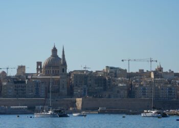 Citizenship by Investment Malta: What Ended and What Remains in 2026 — Beautiful view of Valletta with boats in foreground, highlighting iconic architecture under a clear blue sky.