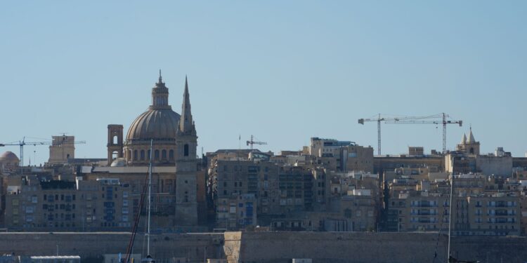 Citizenship by Investment Malta: What Ended and What Remains in 2026 — Beautiful view of Valletta with boats in foreground, highlighting iconic architecture under a clear blue sky.