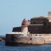Malta Citizenship by Investment: Why the Programme Closed in 2025 — A striking lighthouse stands by ancient fortifications on the seaside at Valletta, Malta.