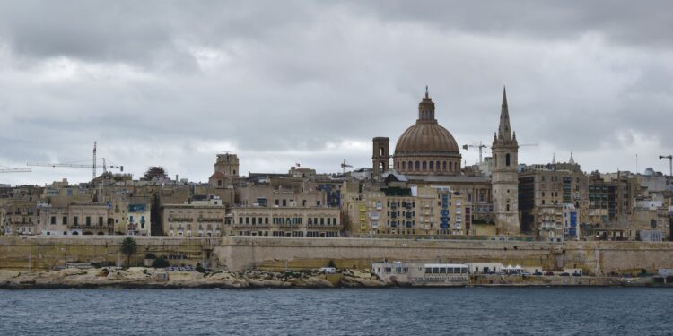 Malta Citizenship by Investment: Why the Programme Ended in 2025 — The iconic skyline of Valletta, Malta featuring St. Paul's Cathedral under a moody sky.