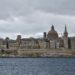 Malta Citizenship by Investment: Why the Programme Ended in 2025 — The iconic skyline of Valletta, Malta featuring St. Paul's Cathedral under a moody sky.