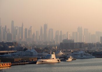 Tax-Free Countries in the World: Where Personal Income Tax Is Zero — Dubai Marina with luxury yachts against a skyline of iconic skyscrapers in the morning light.