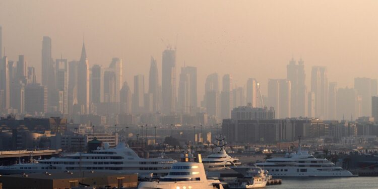 Tax-Free Countries in the World: Where Personal Income Tax Is Zero — Dubai Marina with luxury yachts against a skyline of iconic skyscrapers in the morning light.