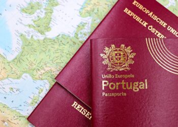 Why the Cheapest Citizenship by Investment Programmes Are Often the Worst Deal — Close-up of Portuguese and Austrian passports lying on a map of Europe, symbolizing travel and mobility.