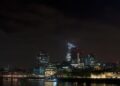 Non-Dom Tax Status UK: What the 2025 Abolition Means for Residents — Dramatic night view of London's skyline featuring modern skyscrapers and the historical Tower of London.