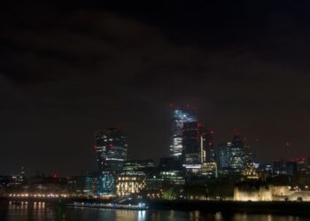 Non-Dom Tax Status UK: What the 2025 Abolition Means for Residents — Dramatic night view of London's skyline featuring modern skyscrapers and the historical Tower of London.