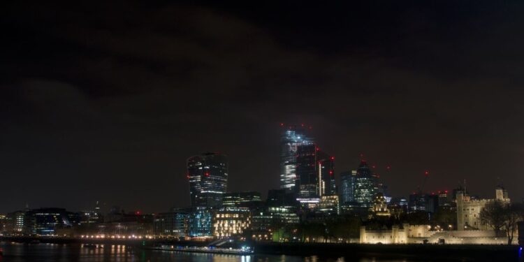 Non-Dom Tax Status UK: What the 2025 Abolition Means for Residents — Dramatic night view of London's skyline featuring modern skyscrapers and the historical Tower of London.