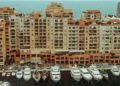 Tax-Free Countries in Europe: Monaco, Gibraltar and Territorial Rules — A stunning aerial photo showcasing luxury yachts moored at a waterfront with apartment buildings in Monaco.