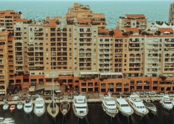 Tax-Free Countries in Europe: Monaco, Gibraltar and Territorial Rules — A stunning aerial photo showcasing luxury yachts moored at a waterfront with apartment buildings in Monaco.