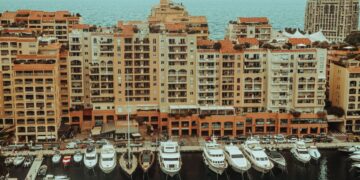 Tax-Free Countries in Europe: Monaco, Gibraltar and Territorial Rules — A stunning aerial photo showcasing luxury yachts moored at a waterfront with apartment buildings in Monaco.