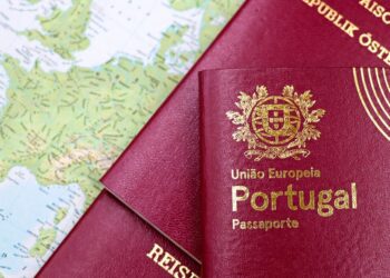 Why the Cheapest Citizenship by Investment Programmes Are Often the Worst Deal — Close-up of Portuguese and Austrian passports lying on a map of Europe, symbolizing travel and mobility.
