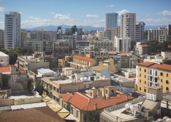 Cyprus Golden Visa: Investment Options, Costs & Application Timeline — Skyline view of Nicosia's diverse architecture under a clear blue sky.