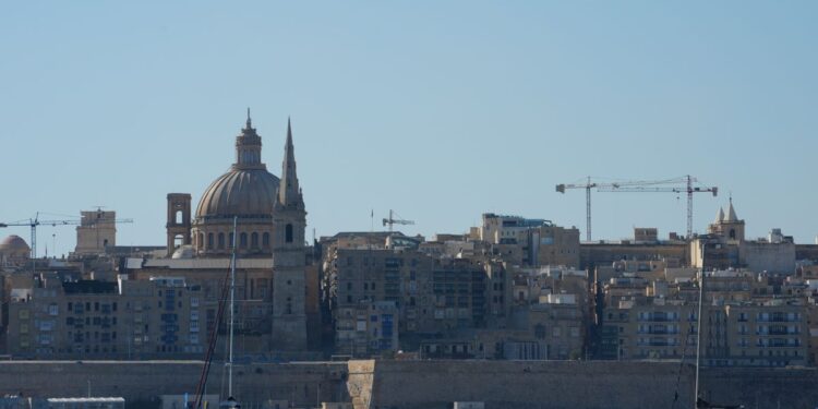 Citizenship by Investment Malta: What Ended and What Remains in 2026 — Beautiful view of Valletta with boats in foreground, highlighting iconic architecture under a clear blue sky.