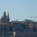 Citizenship by Investment Malta: What Ended and What Remains in 2026 — Beautiful view of Valletta with boats in foreground, highlighting iconic architecture under a clear blue sky.