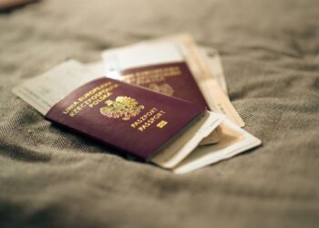 Second Passport: Investment Routes and Costs in 2026 — A close-up of a Polish passport and travel documents placed on a fabric surface, symbolizing travel and identity.