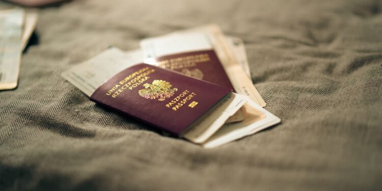 Second Passport: Investment Routes and Costs in 2026 — A close-up of a Polish passport and travel documents placed on a fabric surface, symbolizing travel and identity.