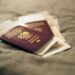 Second Passport: Investment Routes and Costs in 2026 — A close-up of a Polish passport and travel documents placed on a fabric surface, symbolizing travel and identity.