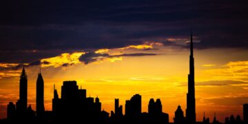 Dubai Golden Visa: Official Investment Minimums and Application Routes — Captivating silhouette of Dubai's skyline with vibrant sunset colors and Burj Khalifa dominating the scene.