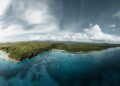 Vanuatu Citizenship by Investment: 2026 Programme Guide — A breathtaking aerial view of the lush green coastline of Vanuatu, surrounded by crystal clear waters.