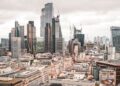 Non-Dom Tax: Complete UK Guide to Abolished Rules and New Regime — A stunning aerial view of London's modern skyscrapers under overcast skies, showcasing its architectural marvels.