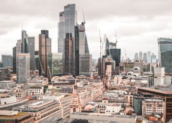 Non-Dom Tax: Complete UK Guide to Abolished Rules and New Regime — A stunning aerial view of London's modern skyscrapers under overcast skies, showcasing its architectural marvels.