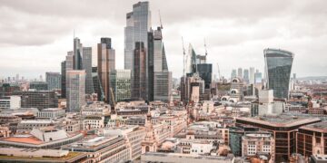 Non-Dom Tax: Complete UK Guide to Abolished Rules and New Regime — A stunning aerial view of London's modern skyscrapers under overcast skies, showcasing its architectural marvels.