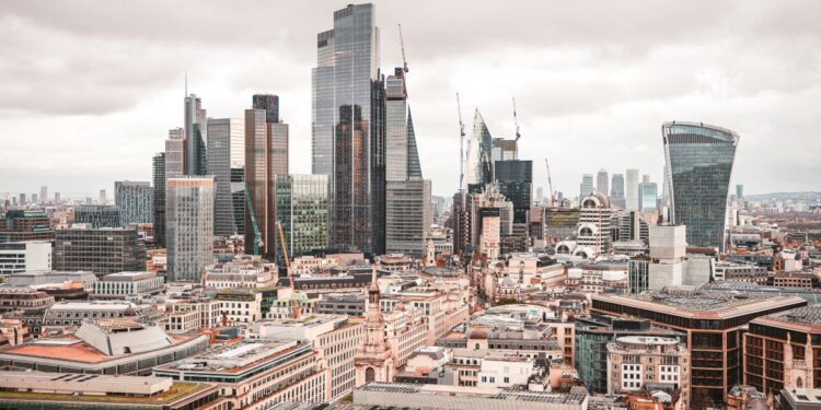 Non-Dom Tax: Complete UK Guide to Abolished Rules and New Regime — A stunning aerial view of London's modern skyscrapers under overcast skies, showcasing its architectural marvels.