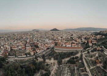 Greek Golden Visa: Investment Routes, Costs & Residency Timeline — A stunning aerial view of Athens cityscape at sunrise, showcasing historical landmarks.