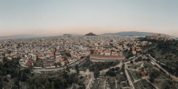 Greek Golden Visa: Investment Routes, Costs & Residency Timeline — A stunning aerial view of Athens cityscape at sunrise, showcasing historical landmarks.