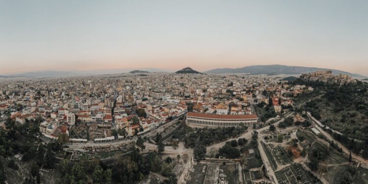 Greek Golden Visa: Investment Routes, Costs & Residency Timeline — A stunning aerial view of Athens cityscape at sunrise, showcasing historical landmarks.