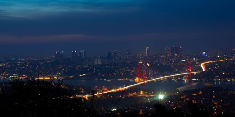 Turkish Citizenship by Investment: The $400,000 Route to a Second Passport — Illuminated Bosphorus Bridge and Istanbul cityscape captured at night creating a breathtaking urban scene.