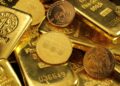 Stacked gold bars in secure vault storage facility