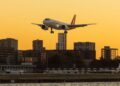 Aircraft over a city skyline, illustrating wealth migration