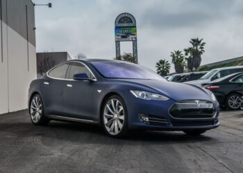 Tesla dealership storefront in California showing electric vehicles on display
